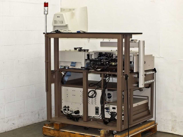 Pacific Western Systems P5NMS wafer prober rear three-quarter view on pallet showing frame structure, rear cable routing, and lower cabinet