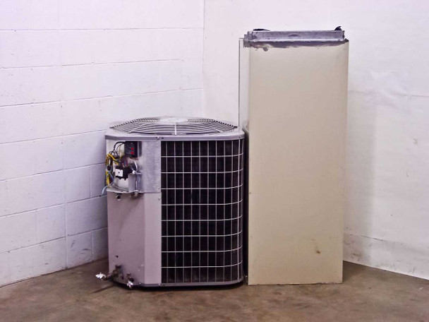 Carrier FB4ANF060 outdoor condenser and air handler — rear/side view showing condenser fan guard and back panel of air handler