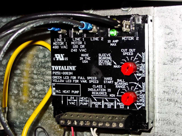 Close-up of Totaline P251-0083H motor protection and variable speed control module — label showing wiring diagram, bearing range settings, and heat pump configuration