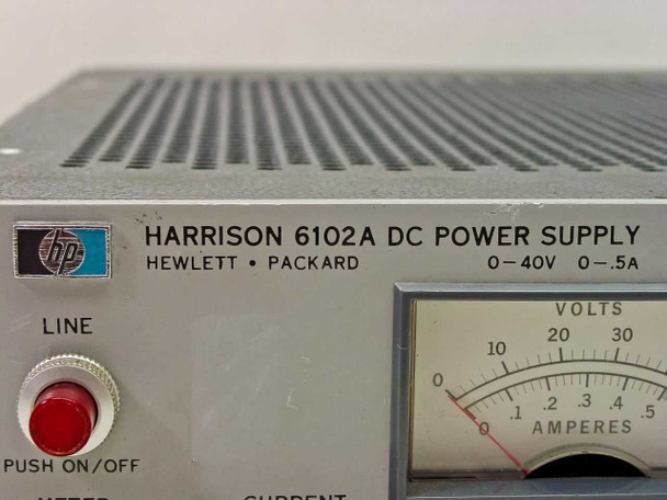 HP Harrison 6102A DC Power Supply – close-up of Hewlett-Packard logo, nameplate reading 0-40V 0-.5A, and dual-scale analog meter (VOLTS and AMPERES)