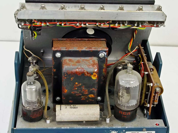 Macbeth TD-102 — interior view with cover removed showing heavily rusted transformer, two vacuum tubes (RCA and unlabeled), wiring harness, and capacitor