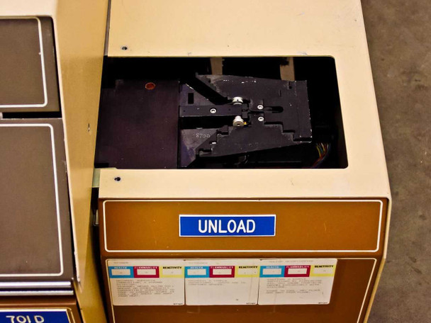 Tegal 701 unload cassette station open top view showing wafer arm transport mechanism, with sensitivity chart labels on door