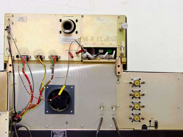 Tegal 803 – rear internal view showing vacuum pump port, coolant connections, temp readout connectors, cooling fan, gas manifold valves, and Tegal label plate