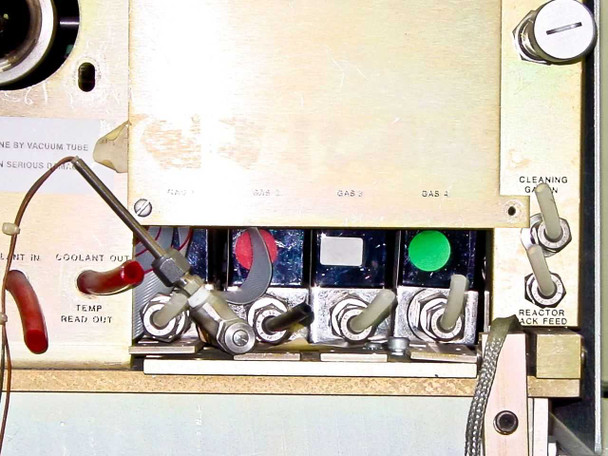 Tegal 803 – gas manifold panel close-up showing Gas 1 through Gas 4 toggle valves with indicator caps, Coolant In/Out ports, Temp Readout connector, Cleaning Gas valve, and Reactor Back Feed valve