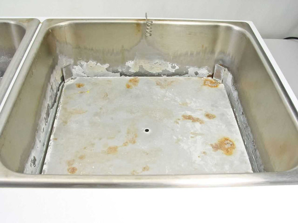Right bath interior showing heavier mineral scale buildup, rust staining, exposed heating element coil, and heating plate