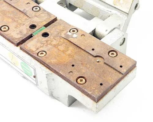 Hollywood Film Company PSC 16 – close-up of bronze/steel rail base showing rust, surface oxidation, and mounting holes