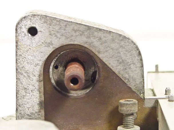 Hollywood Film Company TS-16 — close-up of center pivot mount showing exposed brass pivot post, mounting holes, and knurled adjustment screw; razor blade swing arm absent