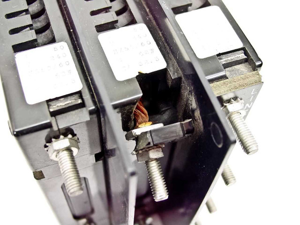 Close-up of cracked and broken plastic housing on Airpax 55-700048 circuit breaker with visible internal damage