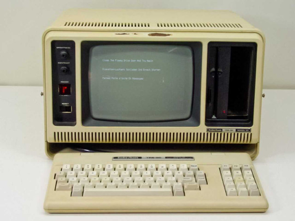 Radio Shack TRS-80 Model 4P – front view with keyboard deployed, CRT displaying floppy error prompt, empty floppy bay at right side of unit