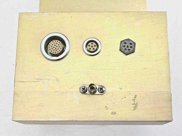 Exterior face panel of brass enclosure box showing large 30-pin circular connector, 7-pin circular connector, hexagonal 6-pin connector, and small coaxial connector