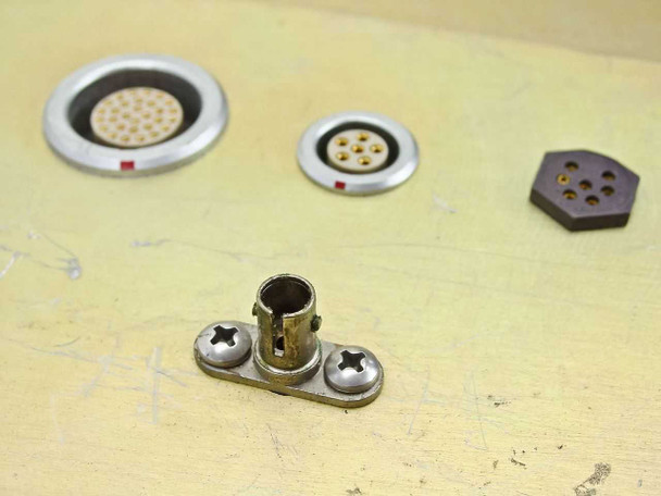 Close-up of connector panel – detail of 30-pin and 7-pin circular connectors and hexagonal 6-pin connector with visible contact pins; small coaxial connector bracket below