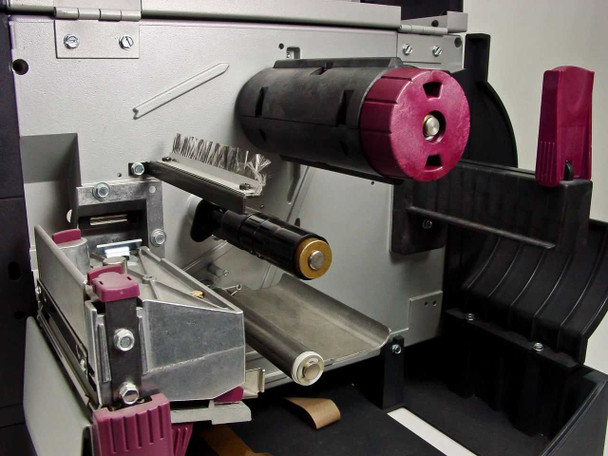 Zebra Z4 label printer internal media and ribbon drive mechanism close-up showing ribbon spool hub and platen roller