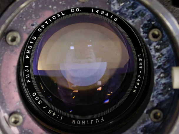 Close-up of Fujinon 300mm f/4.5 lens element with Fuji Photo Optical Co. markings and serial number 149413, lens made in Japan