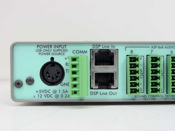 Sound Control Technologies ASP-8x8 rear panel close-up – POWER INPUT label showing +5VDC @ 1.5A and ±12VDC @ 0.2A, 5-pin DIN connector, COMM port, and DSP Link In/Out RJ ports