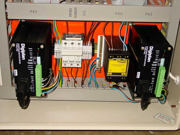 OEM 6200 cabinet interior lower section showing two Digiplan stepper motor drives, circuit breaker, FEA power supply unit, and wiring