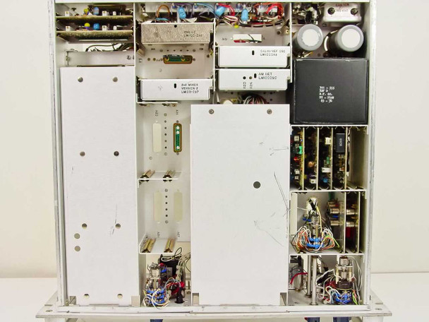 Microdyne 1100-AR(01) interior side view – internal card cage subassemblies, populated and empty module bays, large filter capacitors, and transformer assembly
