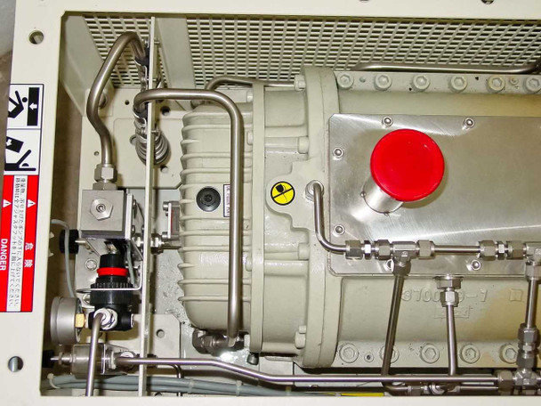 Ebara 40X20 internal close-up of pump body left side showing plumbing fittings, pressure regulator, warning labels, and red emergency stop button