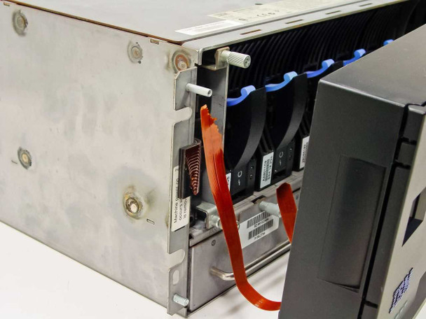 IBM 7133-D40 interior side view showing SSA hard drive modules with blue pull tabs and ribbon cables