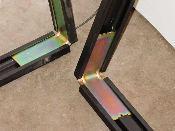 OmniMount ARC-FPD frame corner closeup showing iridescent corner bracket hardware detail