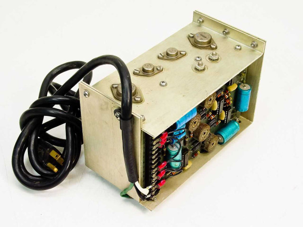 Transistor Devices Inc SPS 1676 switching power supply – opposite three-quarter view showing PCB with capacitors, resistors, and wiring harness with red and black output leads