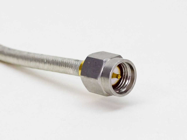 KMW 140223-2 close-up of SMA male connector end with gold center pin and stainless hex body on braided cable