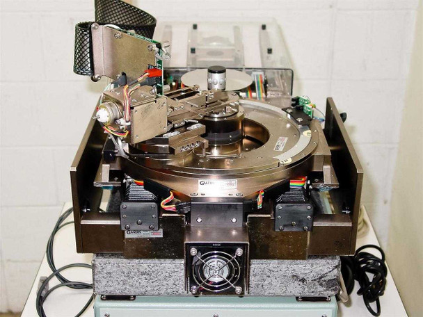 Guzik S1701 SpinStand top-down view showing precision granite base, spindle, actuator arm, stepper motors, and multiple PCBs