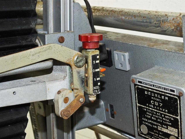 Beseler CB7 negative tilt adjustment mechanism with red knob and NEG TILT scale, showing surface rust on base platform