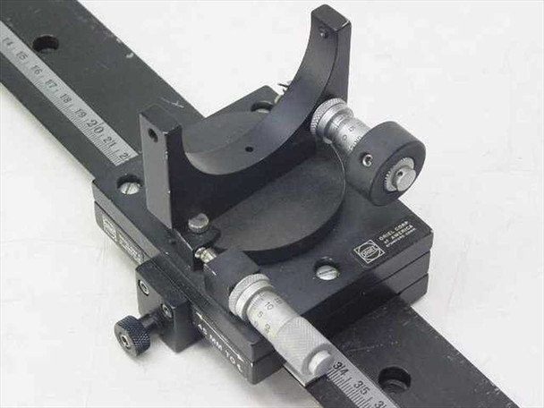 Oriel optical alignment rail – angled close-up of mirror mount, Oriel micrometer, and stage carriage on rail with scale markings