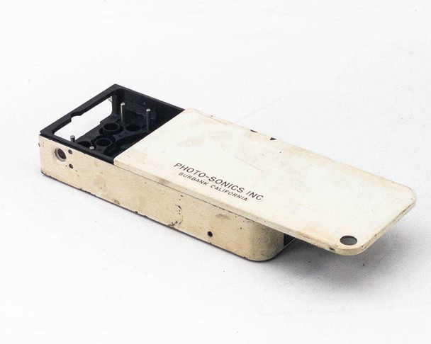 Photo-Sonics LB-24A KB-19 film magazine shell — three-quarter view showing white painted exterior body and open black interior housing with film transport apertures