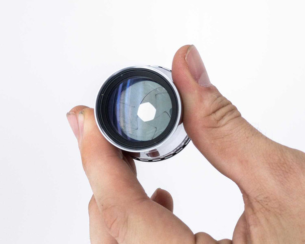 Photo-Sonics KB-19A lens – front element view at angle showing crazing or cracking on lens coating