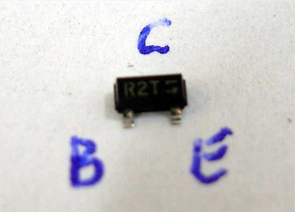 Single Fairchild MMBT2222AR-R R2T SOT-23 transistor on white surface with handwritten C (Collector), B (Base), E (Emitter) pin orientation labels
