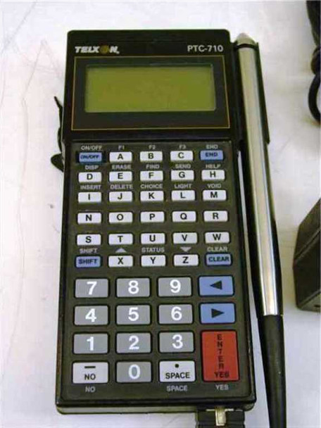 Telxon PTC-710 portable barcode data terminal front view showing full QWERTY and numeric keypad, LCD display, and attached pencil wand scanner