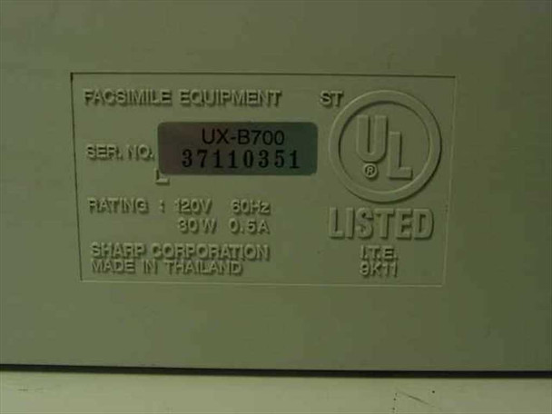 Sharp UX-B700 rating plate showing model number, serial number 37110351, 120V 60Hz 30W 0.5A rating, UL Listed mark, and Made in Thailand by Sharp Corporation