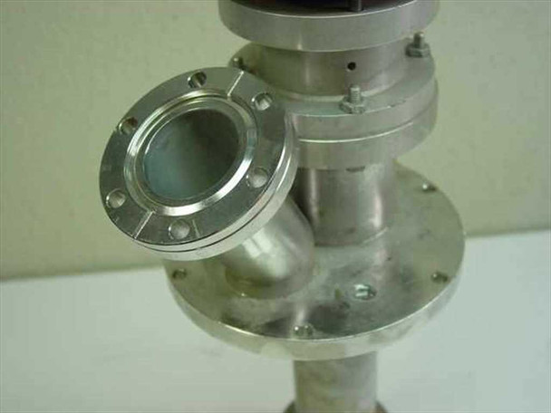 Close-up of vacuum flange and feedthrough fitting on stainless steel drive unit showing conflat-style bolt holes