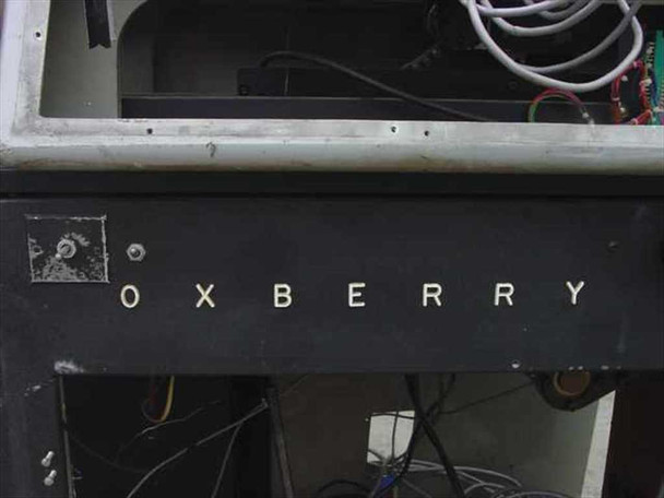 Oxberry 1500 front fascia panel showing embossed OXBERRY lettering with wiring visible in open interior bay