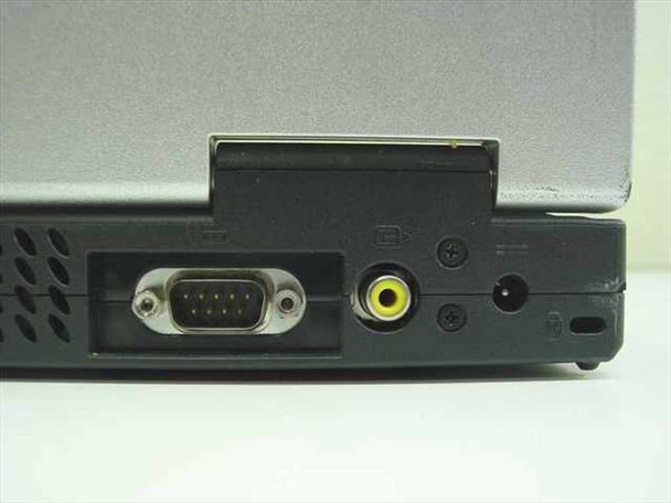 Gateway Solo 9500 – right rear corner showing DB9 serial port, yellow composite/S-Video jack, DC power jack, and PC Card slot