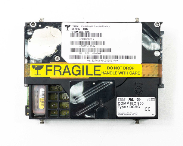 IBM 27H1698 SSA Hard Drive – bottom label view showing IBM COMP IEC 950 Type DCHC label, CE mark, barcode, and fragile sticker