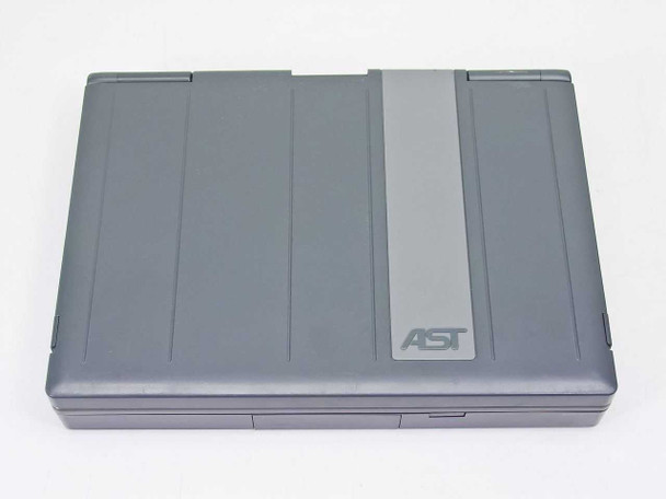 AST PowerExec 3/25SL closed top view — two-tone gray lid design with AST logo
