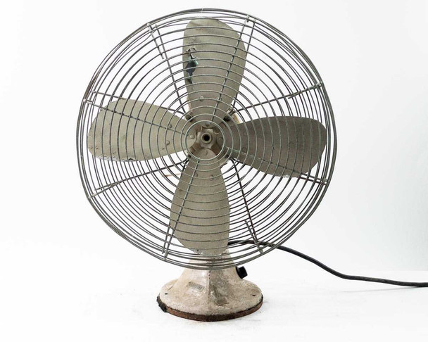 Robbins and Myers CG16 vintage electric desk fan — front-right view showing wire guard, 3 metal blades, cast base, and power cord