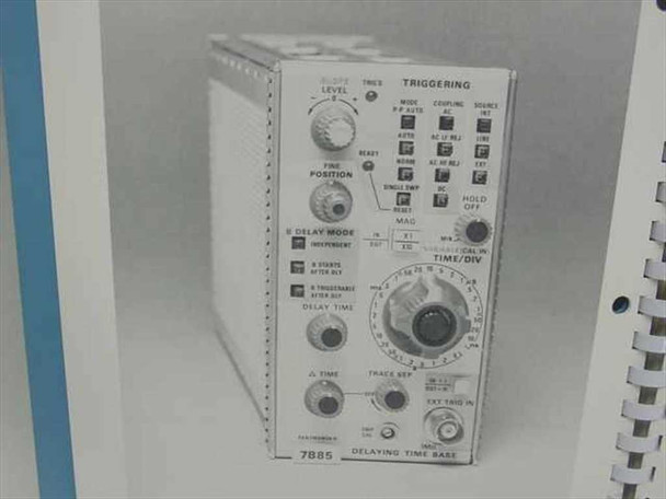 Interior page of Tektronix 7B85 manual showing black-and-white photograph of the 7B85 Delaying Time Base plug-in front panel with triggering, delay mode, and time/div controls