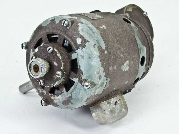 Bell & Howell Filmo 031397 electric motor rear-left view showing circular ventilation openings and flaking paint with heavy wear