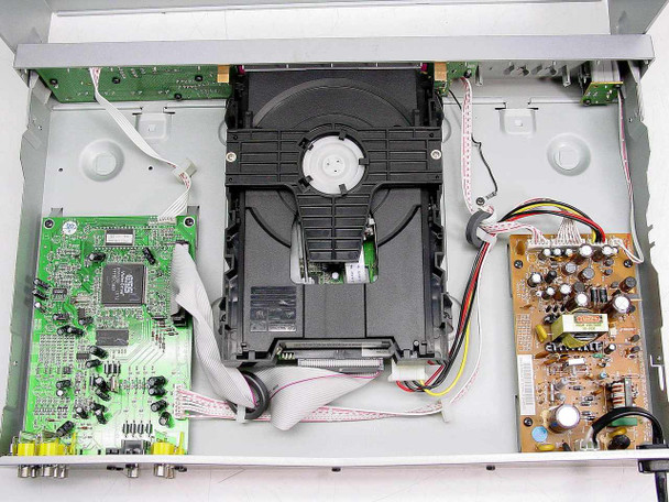 Philips DVD724 internal view with lid removed showing DVD optical drive mechanism, main circuit board, and power supply board