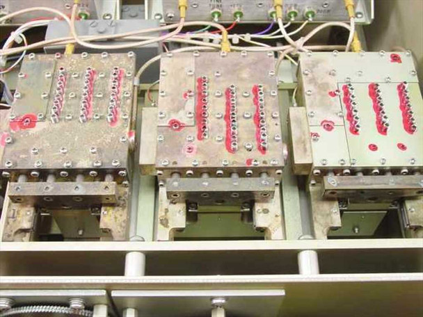 Carnel Labs NM-65T – close-up of three internal shielded RF module assemblies with visible corrosion and red wiring connections on top surfaces