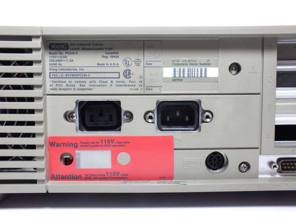 Wang PC240-3 rear panel close-up — dual IEC power connectors, red 115V factory-set warning sticker, DB9 and DB25 I/O ports visible