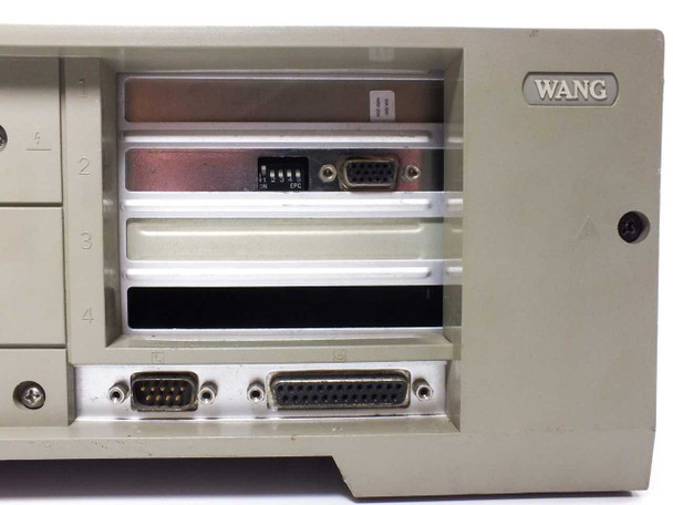 Wang PC240-3 right side panel open — showing four expansion slot bays, DB9 and DB25 rear I/O connectors, DIP switches, and vacant card slots