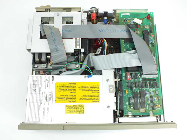Wang PC240-3 interior top view — motherboard, ribbon cables, 5.25-inch floppy drive mechanism, hard drive, and power supply visible with top cover removed