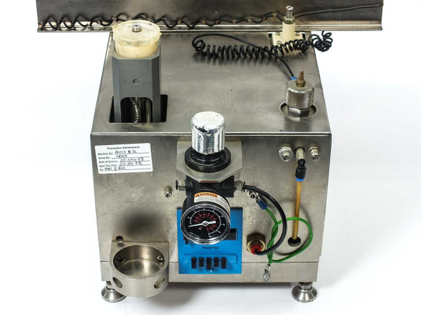 Micro Tooling MT0268 side panel view showing Festo pneumatic pressure regulator with gauge, Festo counter module, coiled air line, and stainless steel body