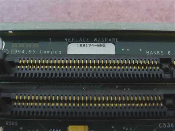 Close-up of Compaq 169174-002 board edge label showing part number 169174-002, 1994.95 Compaq date code, REPLACE W/SPARE marking, and SIMM connector banks