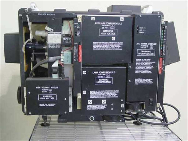 GE Talaria PJ5055C1 — internal module bay open showing Auxiliary Power Module, Lamp Power Module (70/1700), AC Input Module, and High Voltage Module with warning labels; wiring and connectors visible