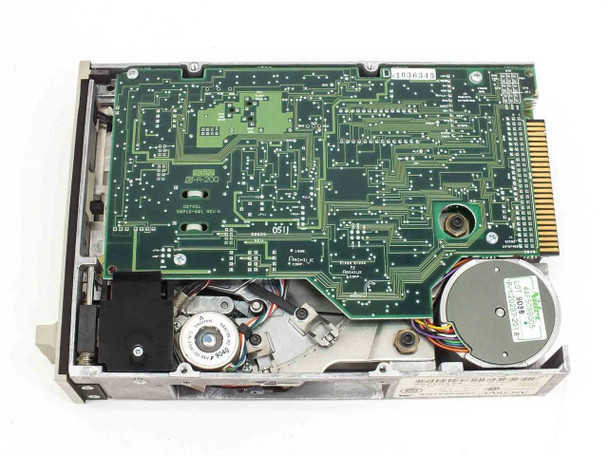 Archive 2150L tape drive – bottom PCB view showing full green logic board with ICs, motor assembly, and QIC-02 edge connector; inventory sticker visible on board